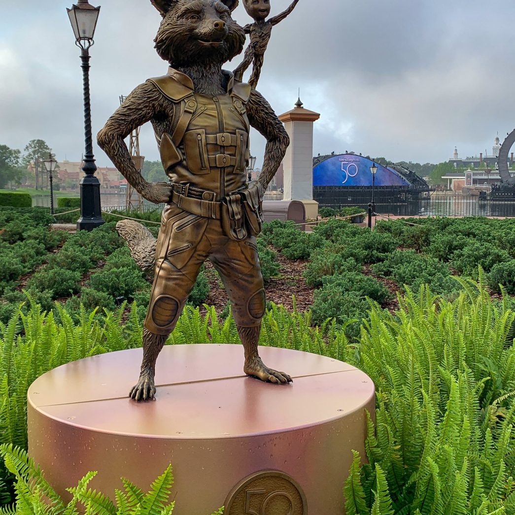 Rocket Racoon and Baby Groot gold statues in the Showcase Plaza, part of the Disney Fab 50 golden statues celebrating Walt Disney World's 50th anniversary in EPCOT.